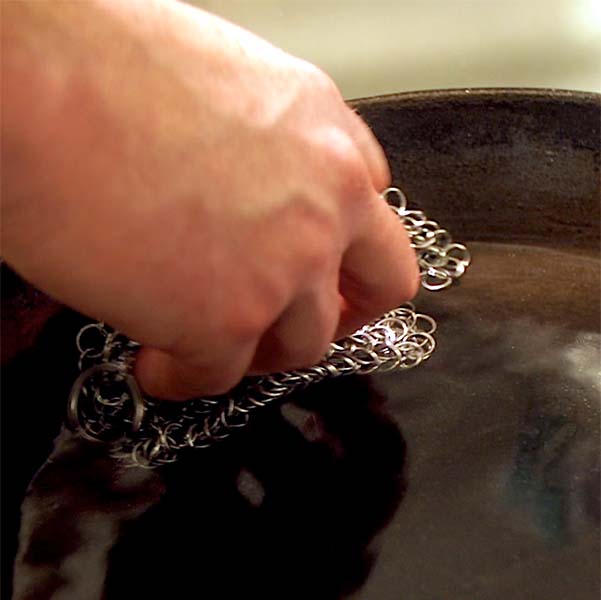 For truly stubborn residue break out the chain mail scrubber to clean, care for cast iron Dutch oven or skillet.