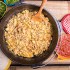 Easy Dutch Oven Breakfast Burritos served with onion, cilantro, jalapano and salsa for garnish.