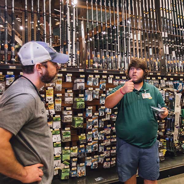 Clint gets a lesson in bass fishing from an associate at Bass Pro Shops at the Pyramid in Memphis, Tennessee prior to trying his luck at Natchez State Park later in the 50 Campfires Field Trip: Great River Road.