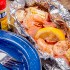 Campfire Shrimp Boil ingredients included in the foil packet are: shrimp, potatoes, sweet corn, sausage, and Old Bay Seasoning.