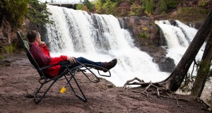 person relaxing in camping chair